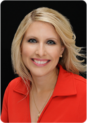 A woman in red shirt smiling for the camera.