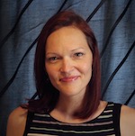 A woman with red hair and a striped shirt.
