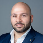 A man with a beard and suit jacket