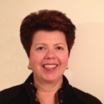 A woman with short hair is smiling for the camera.