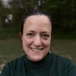 Smiling woman portrait outdoors wearing green sweater